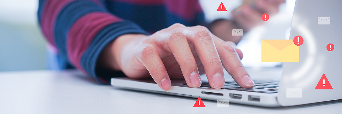 Individual using laptop with email alert notifications