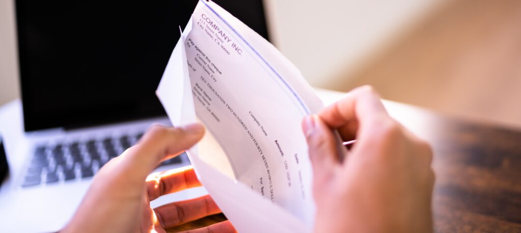Check Being Placed into an Envelope